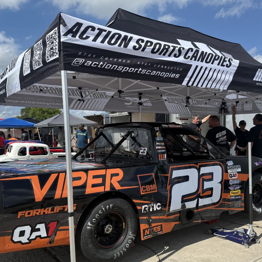 No. 23 Viper Forklifts short-track race truck in the pits under an Action Sports Canopies tent at a Midwest racing event